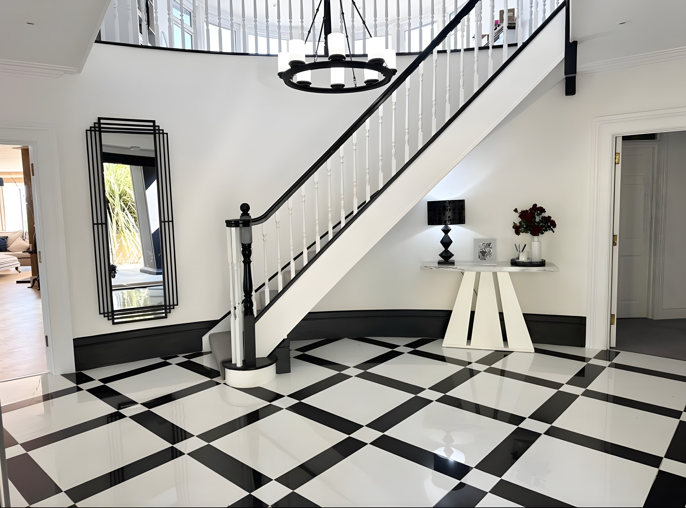 Entrance hall with staircase and black and white floor